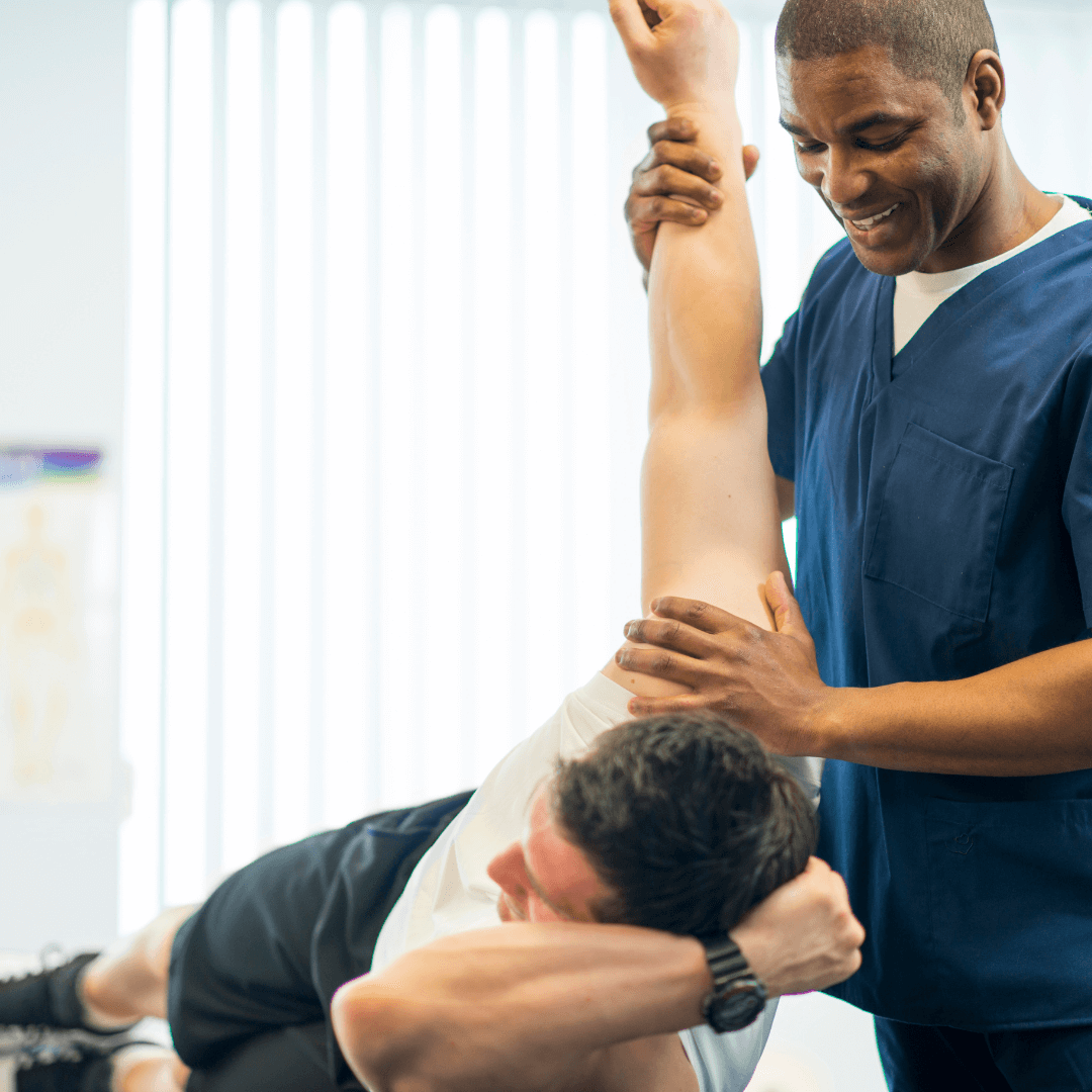 A friendly recovery specialist helps a client stretch and recover, focusing on flexibility and muscle health, highlighting the recovery services.